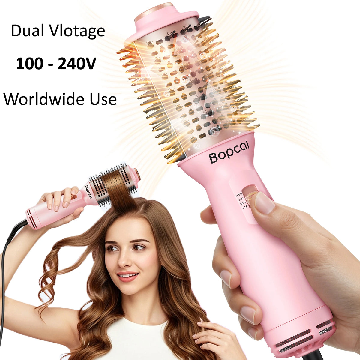 Pink  dual-voltage round hair styling brush with 100–240V worldwide compatibility, shown in hand with a woman styling her hair in the background.