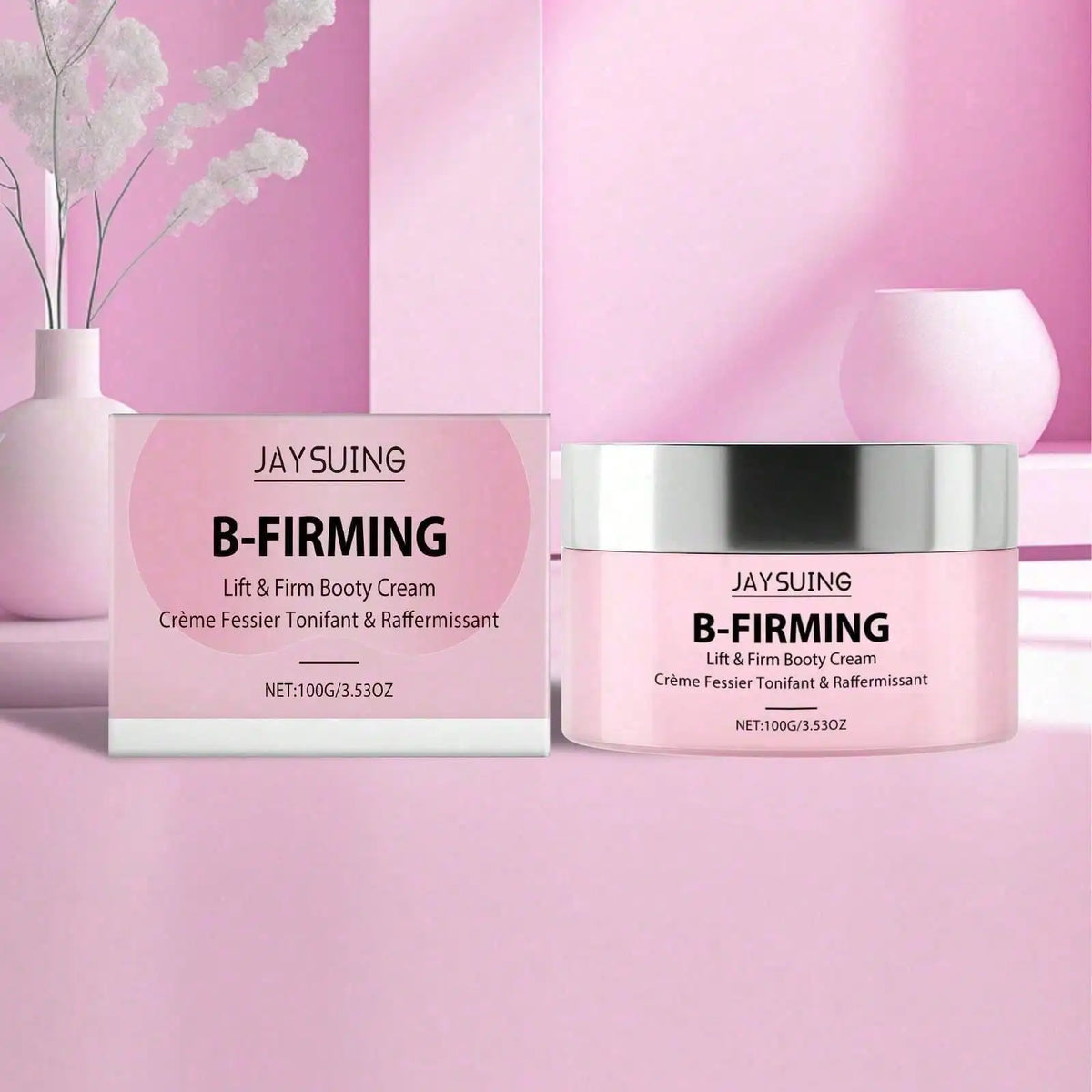 JAYSUING B-FIRMING Lift & Firm Booty Cream in a pink jar with silver lid and matching product box, displayed with white flowers on a pink background.